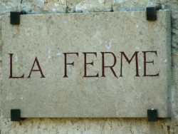 Un peu de silence s'il vous plaît (Panneau en marbre d'une devanture de maison où l'on peut lire "LA FERME")
